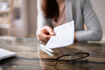 businessperson&#x27;s hand holding cheque