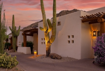 arizona resort under orange sky with cute cactus plant at sunset