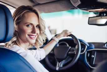 smiling woman sitting in the car