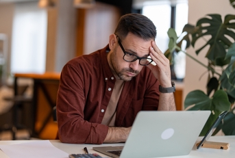 businessman in the home office feeling frustrated 