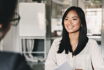 woman smiling and holding resume