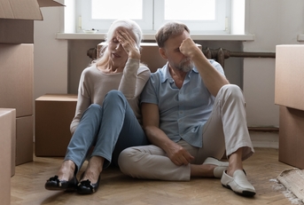 elder couple of homeowners exhausted with relocation