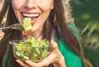 woman eating salad