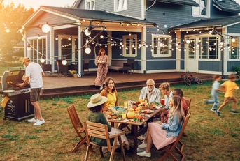 big family and friends celebrating outside at home