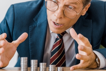 businessman looking at silver coins