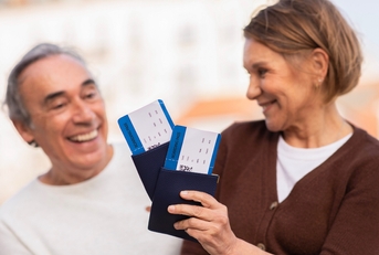 senior tourists holding boarding passes