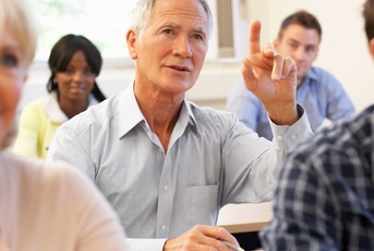 Senior student raising hand in class