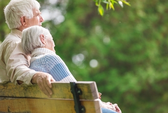 elderly couple resting on a bench