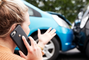 woman on phone after car accident