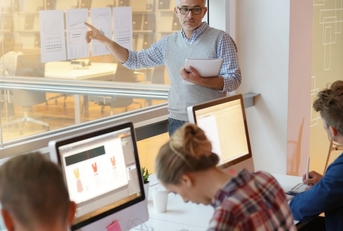 male professor teaching economics to students