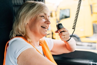 female truck driver talking by radio