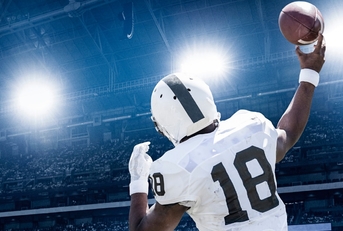 quarterback throwing football in professional game