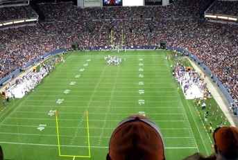 spectators watching football game in stadium
