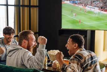 friends watching football match