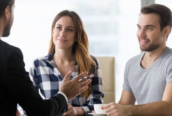 young couple consulting male finance advisor