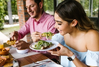 woman eating mexican tacos
