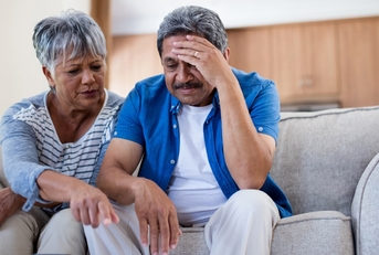 stressed senior couple reviewing bills