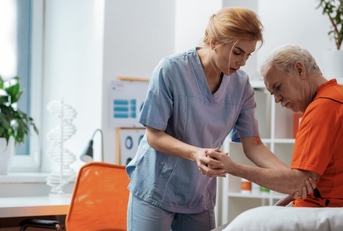 nurse holding her patients hand