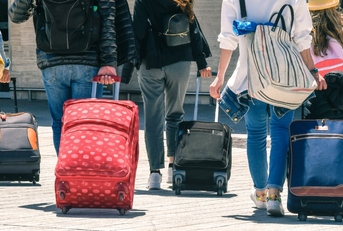 family on vacation with luggage
