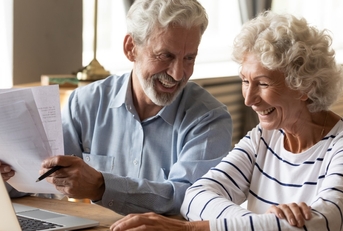 senior couple reviewing bills at table