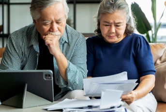 senior couple calculating financial billing