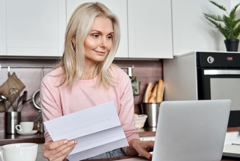 senior woman reviewing bills