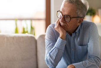 worried senior man sitting alone