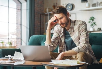 male accountant stressed at tax forms