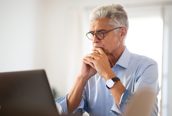 older businessman sitting in office