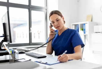 female nurse on phone at work