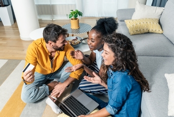 Three people considering credit card options