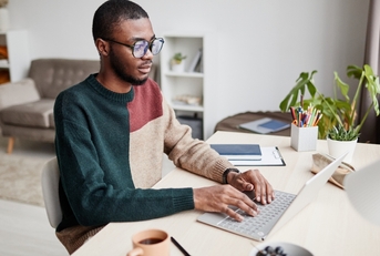 man wearing glasses while working