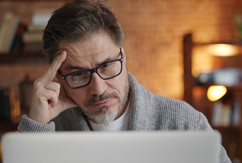 senior man stressed at laptop screen
