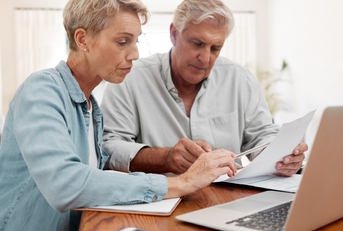 senior couple reviewing mortgage expenses together