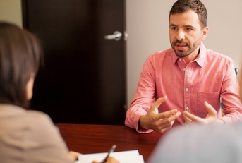 Young man being interviewed for a job position.