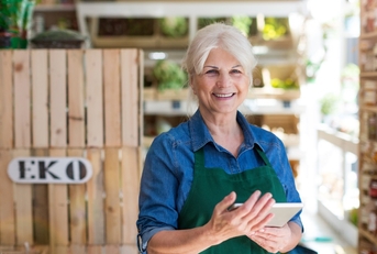 senior shopping assistant using tablet
