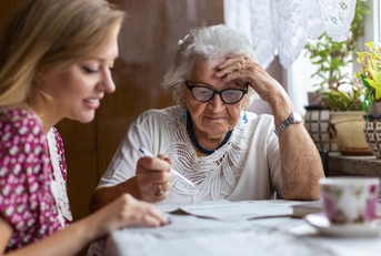 woman helping elderly grandmother