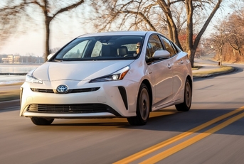 driver driving toyota prius at sunset