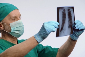 respiratory therapist looking at lungs scan