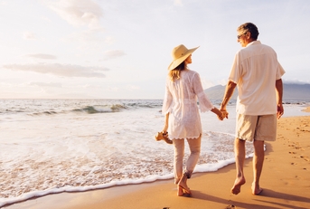 mature couple walking on the beach