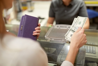 paying money at store cash register