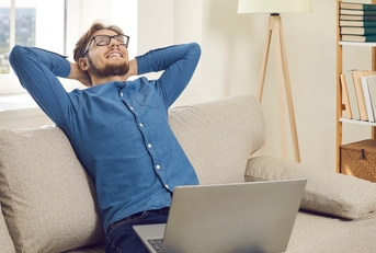 calm young man sits on sofa