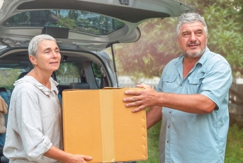 senior couple picking packages from car