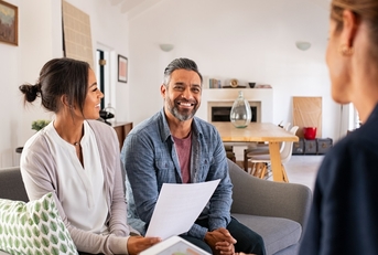 mature couple consulting female finance advisor