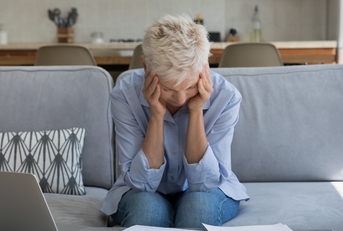 senior woman stressed while working