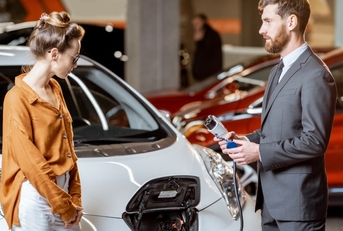 sales manager showing electric car
