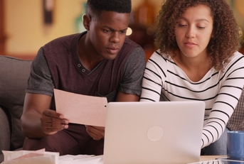 african american couple reviewing bills together
