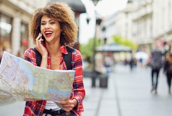 female tourist walking outdoor with map