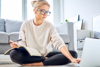 woman using laptop paying bills