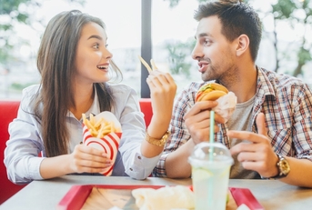 couple eating fast food at restaurant